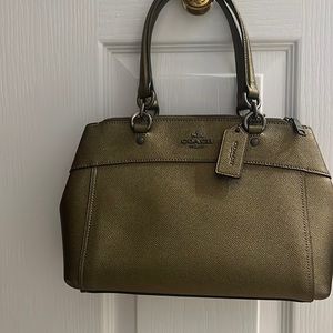 Very new, clean, classy and lightweight Coach bag with two handles.